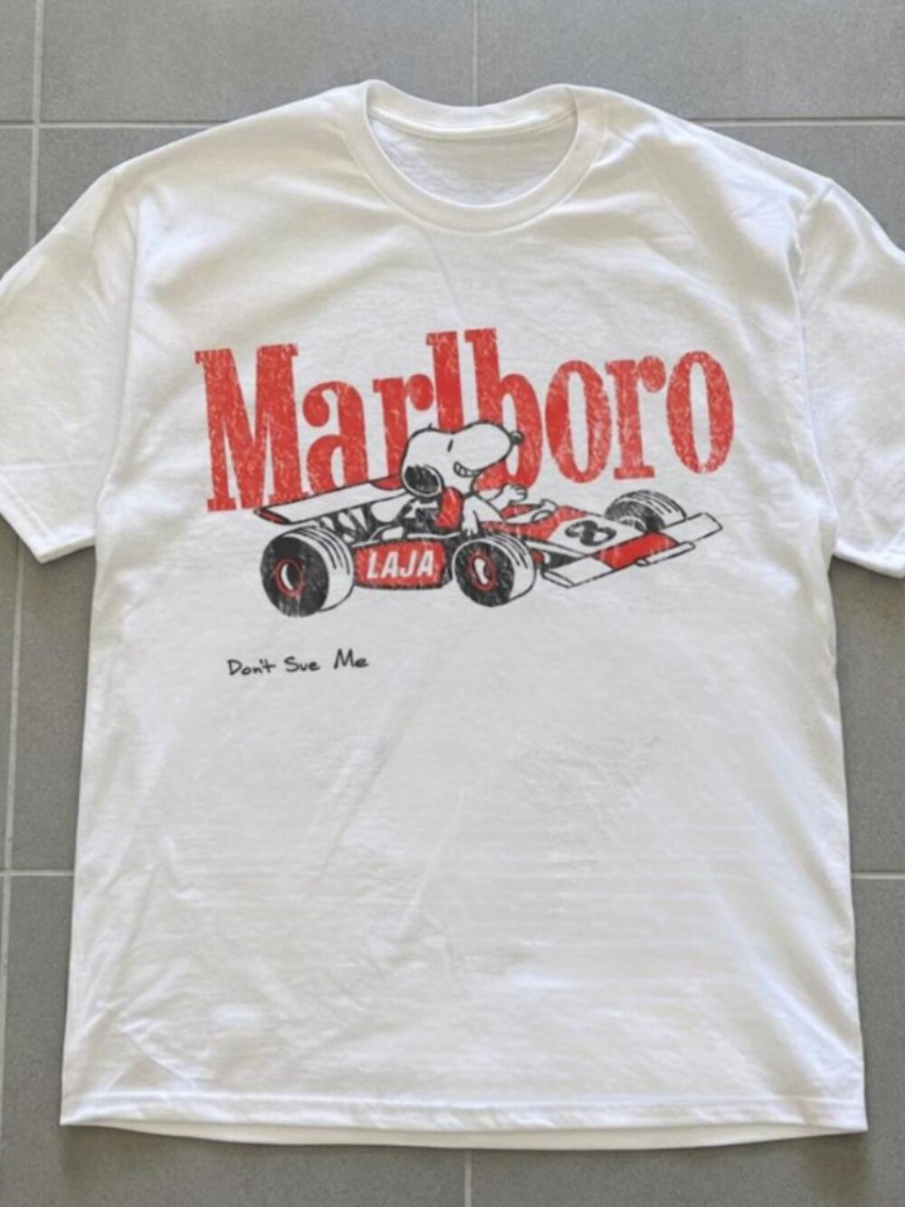 Snoopy racing with 'Marlboro' text and Snoopy in a race car graphic tee